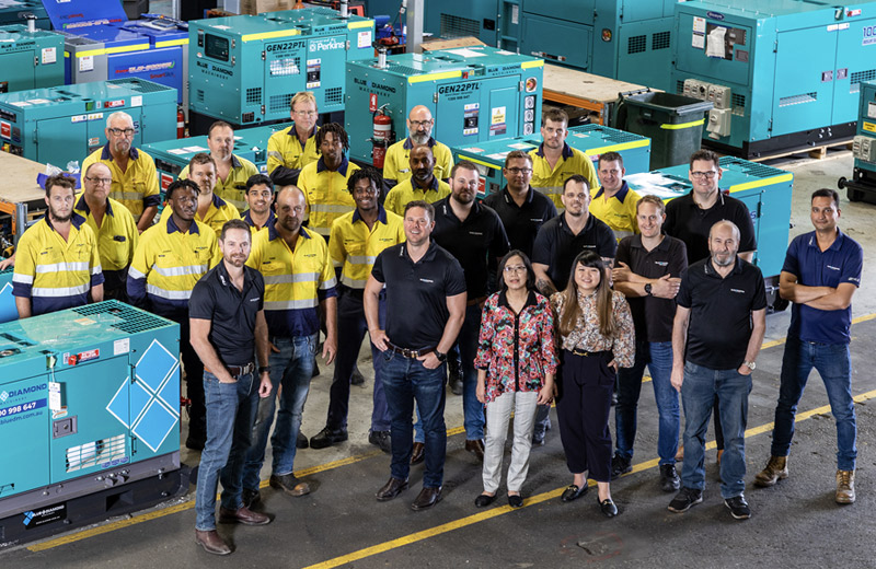 blue diamond team infront of 10kVA standby generator and other prime power gensets in their perth warehouse