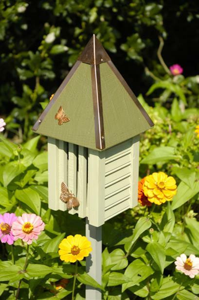 Handcrafted cypress butterfly house with a copper roof and garden stake, designed as a decorative outdoor accent for cottage and farmhouse-style gardens.