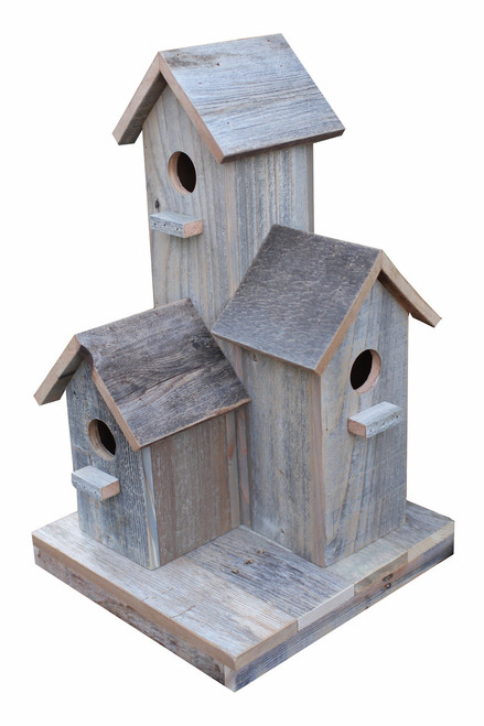 Large rustic barnwood birdhouse handcrafted from reclaimed wood, designed as a statement garden décor piece with functional nesting space.