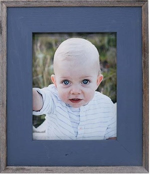 Blue barnwood picture frame displayed in a farmhouse or coastal-inspired space, adding a pop of color with rustic charm.