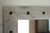 Farmhouse vanity mirror with rustic whitewashed wood frame and western style tack detailing