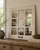Rustic white window pane mirror with distressed farmhouse finish and 9 pane grid design reflecting a cozy neutral living room