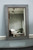 A bold blend of rustic texture and refined design, this mirror serves as both functional décor and a standout statement piece.