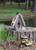 Vintage wren birdhouse handcrafted from rustic wood with charming farmhouse garden style