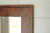 Rustic stained wood wall mirror with clean lines and handcrafted artisan craftsmanship