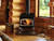 Performer S210 wood stove burning in living room of a log cabin Performer S210 wood stove burning in living room of a log cabin