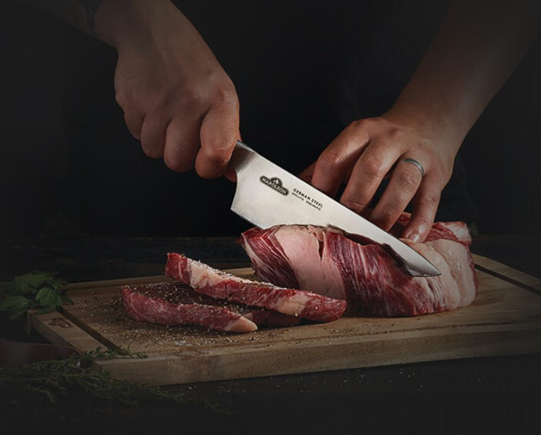 chef's knife cutting meat