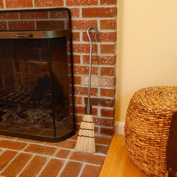 broom next to fireplace