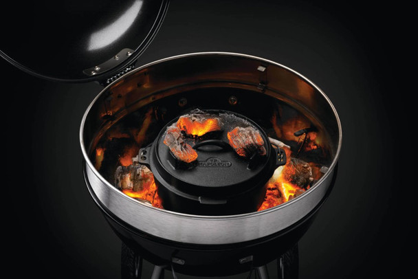 Dutch oven cooking in kettle with coals on top