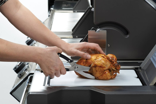 cutting chicken on a grill with poultry shears