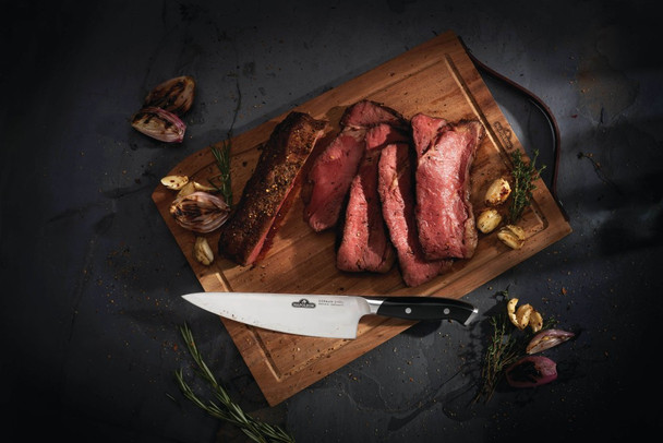 meat, onions, potato on a cutting board with knife