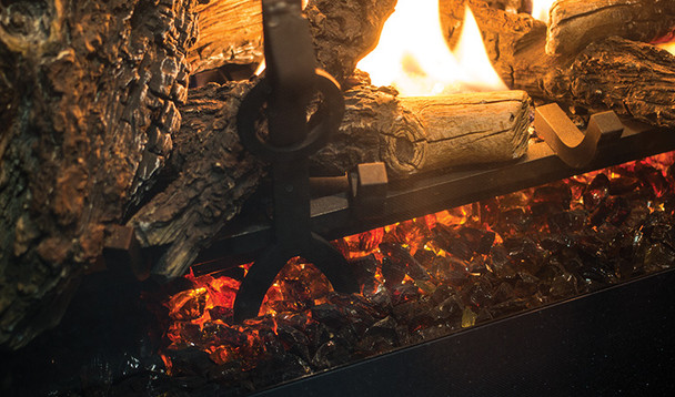 traditional log set, grate, embers and andirons burning