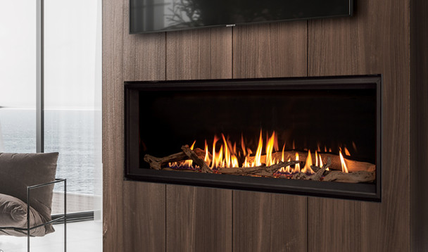 C60 Tall fireplace with porcelain enameled liner, driftwood log set burning in a room