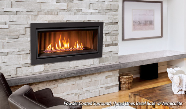 C34 gas fireplace with powder coated surround, fluted liner, bezel base with vermiculite burning in a living room
