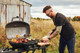 man grilling in field