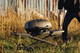 man transporting grill over field