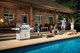grill on side of pool with family