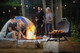 people outside grilling food