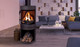 black S50 gas stove with wood pedestal in living room