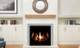 Q3 gas fireplace with black enameled liner and log set burning in a living room