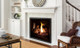 Q3 gas fireplace with black enameled liner and log set burning in a living room