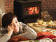 Lady with chess board, pastries in front of Tahoma 2100 wood stove burning in living room