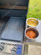 chorizo and scrambled eggs in bowls next to griddle on grill