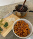 cooked chorizo with scrambled eggs, toppings, side of beans in pot