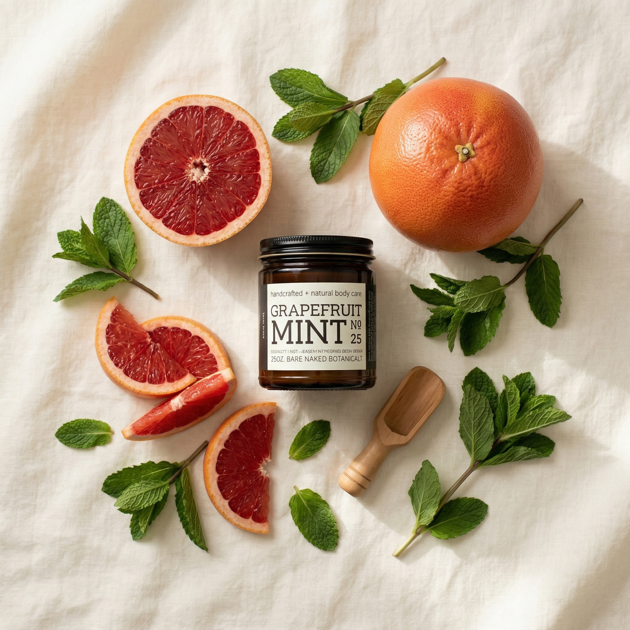Grapefruit mint body scrub in glass jar with citrus and mint botanical ingredients