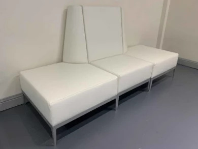 White modular lounge seating with high backs for a dealership waiting area