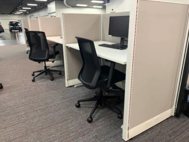 Cubicle workstations with task chairs and monitors in an Orlando dealership office
