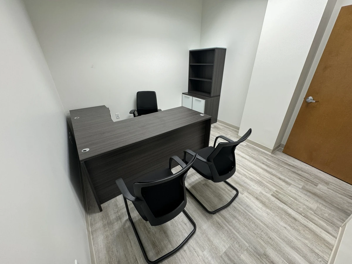 Orlando law firm private office with L-shaped desk, task chair, and cantilever guest seating