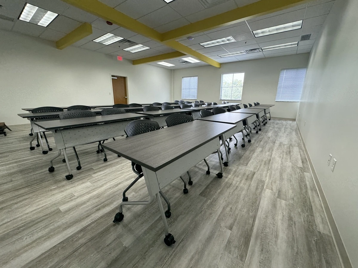 Wide view of flexible training room with casters-mounted tables and stackable seating