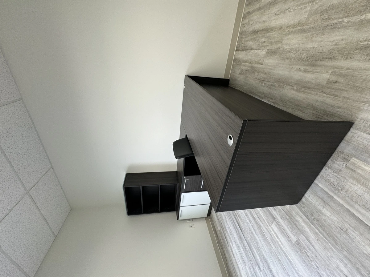 Charcoal L-shaped desk with grommet, file drawers, and open bookcase hutch
