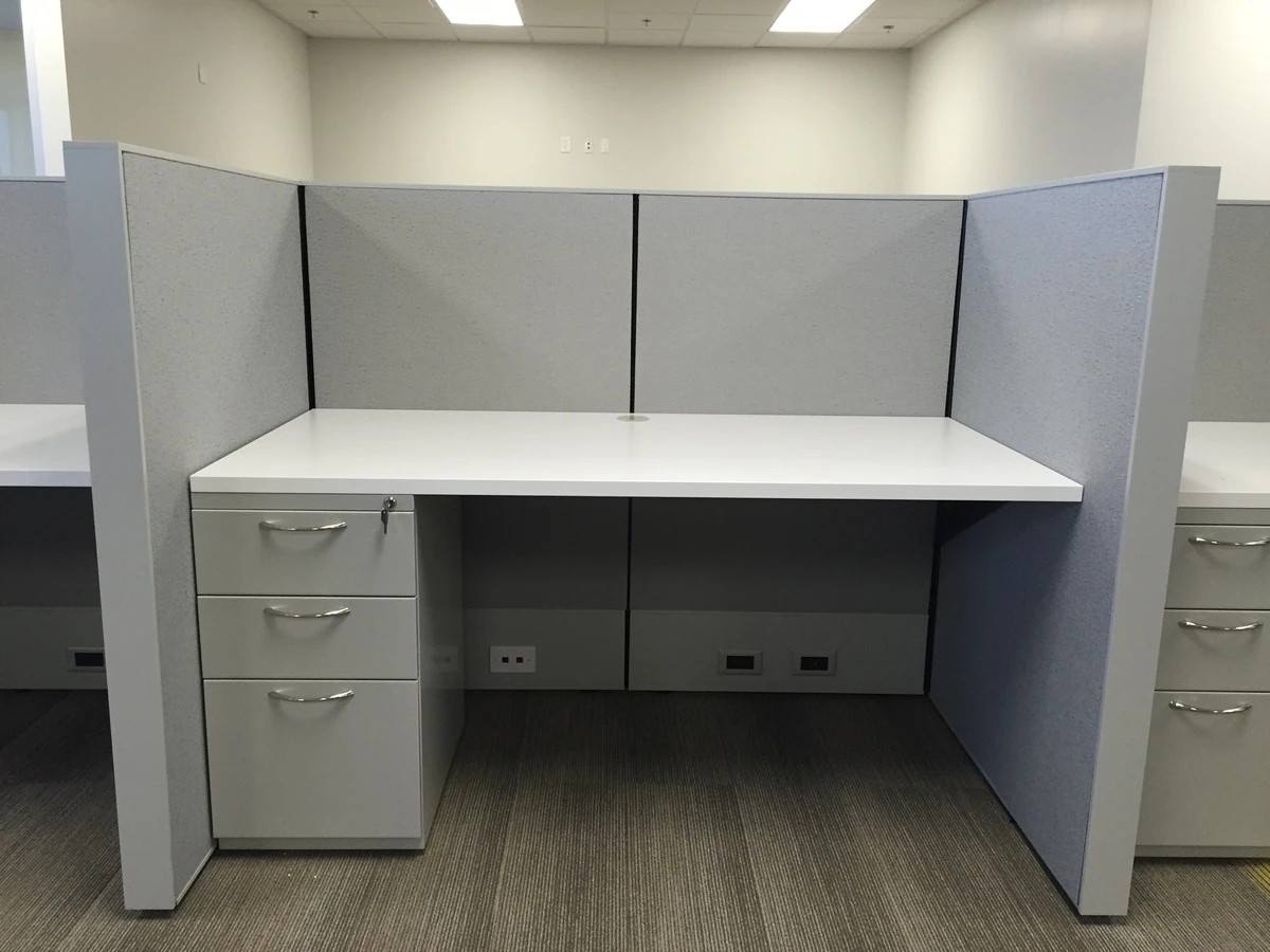 High-panel workstation with white desk surface, locking pedestal drawers, and built-in power