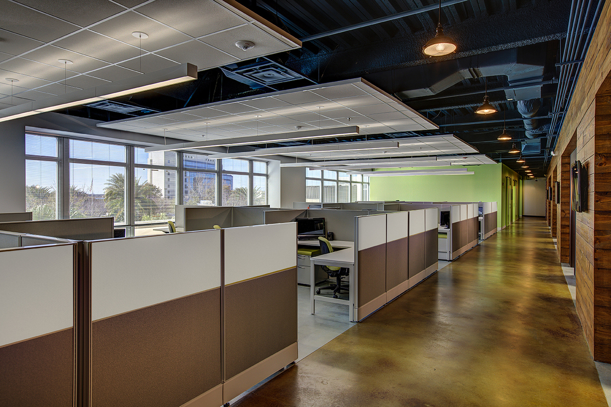 Open office cubicle workstations with taupe and white panels and green task chairs, Orlando