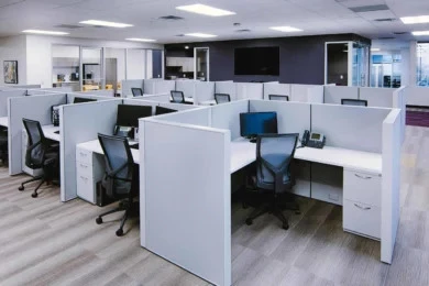Open office workstations with white panels, file pedestals, and mesh task chairs in Orlando