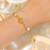 bracelet acier inoxydable doré avec perle baroque nid d'oiseau, rose artisanale, et zircon