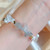 bracelet jonc inoxydable avec labradorite, quartz clair, perles baroques et accessoires dorés