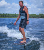 Low angle shot of wakefoiler hovering above the wake on the Pilot Foil Package