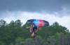 Rider in air using 2026 Connelly Reverb wakeboard and Empire bindings
