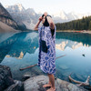 Model wearing Nomadix Changing Poncho at glacial lake