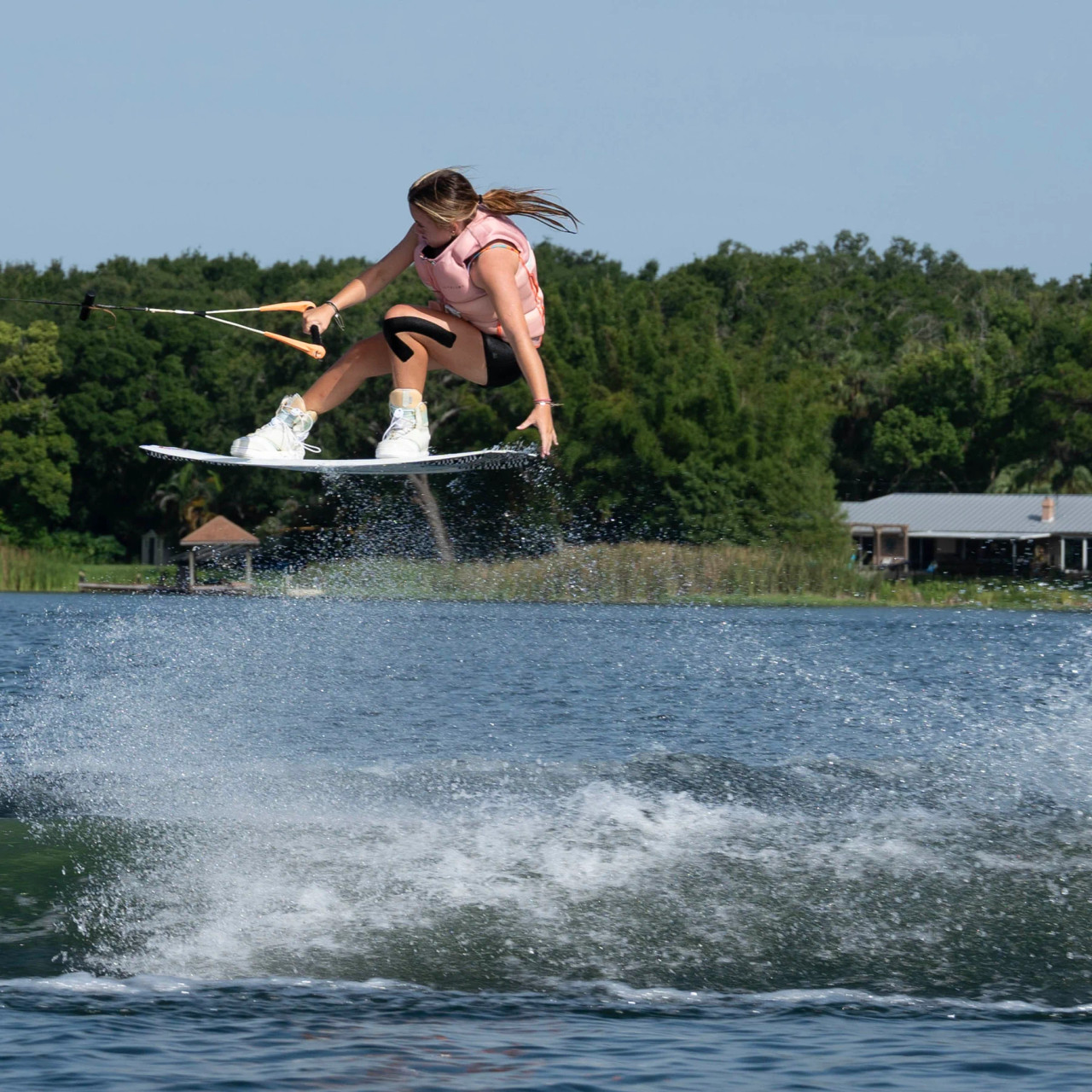 Jetpilot women's armada vest in action wakeboarding Jetpilot women's armada vest in action wakeboarding