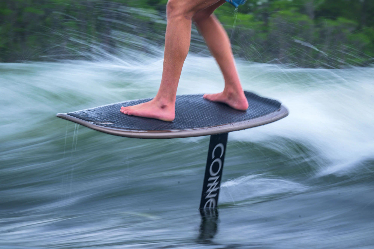 Close-up of rider’s stance on the Connelly Pilot foilboard with EVA traction pad visible