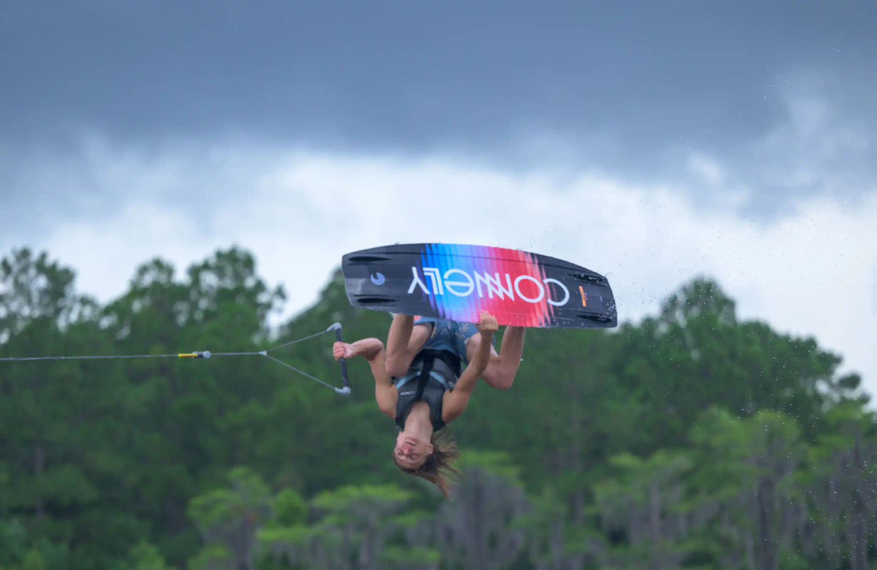 Rider in air using 2026 Connelly Reverb wakeboard and Empire bindings