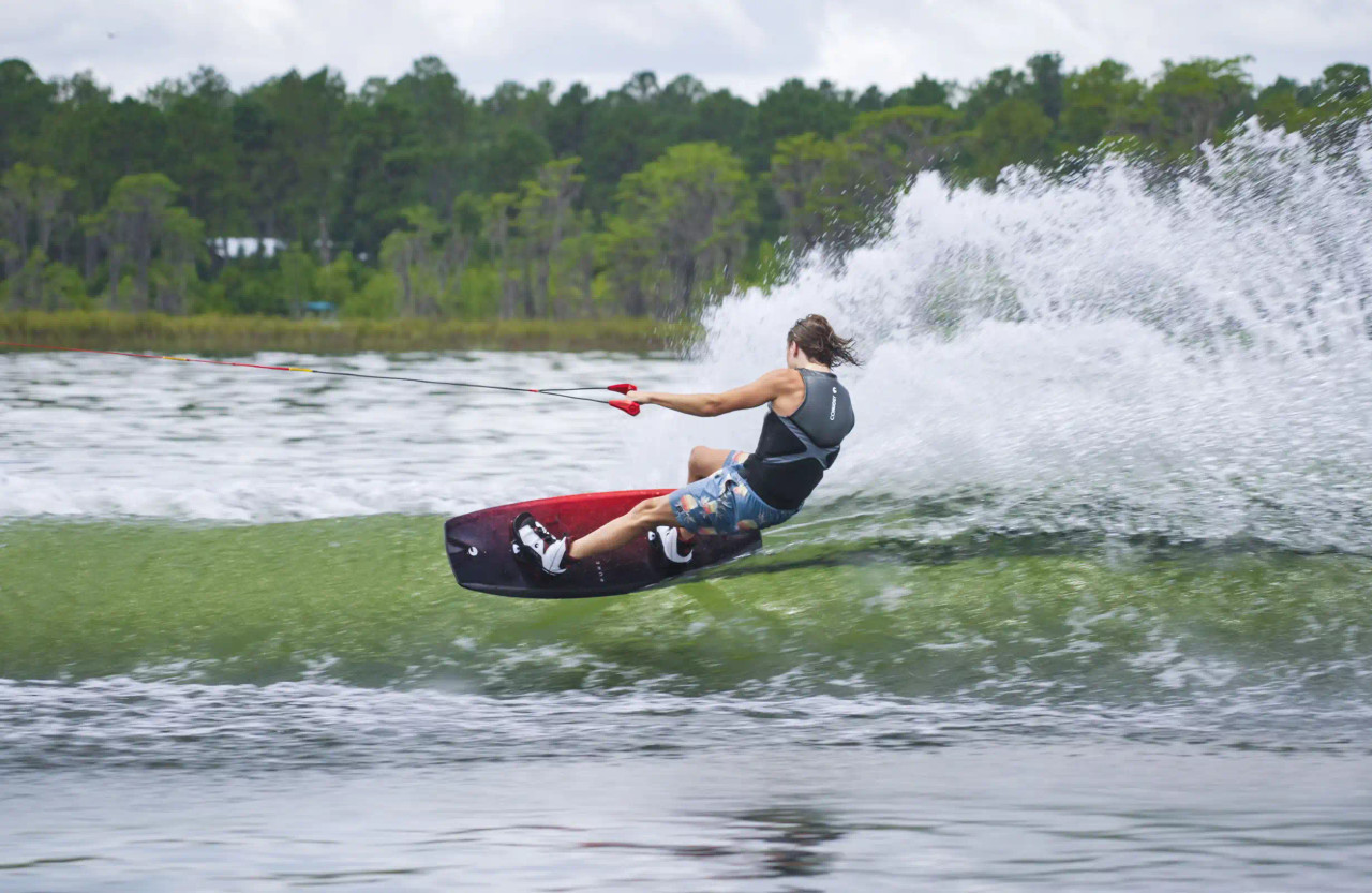 Rider carving on Connelly Pure Wakeboard behind boat