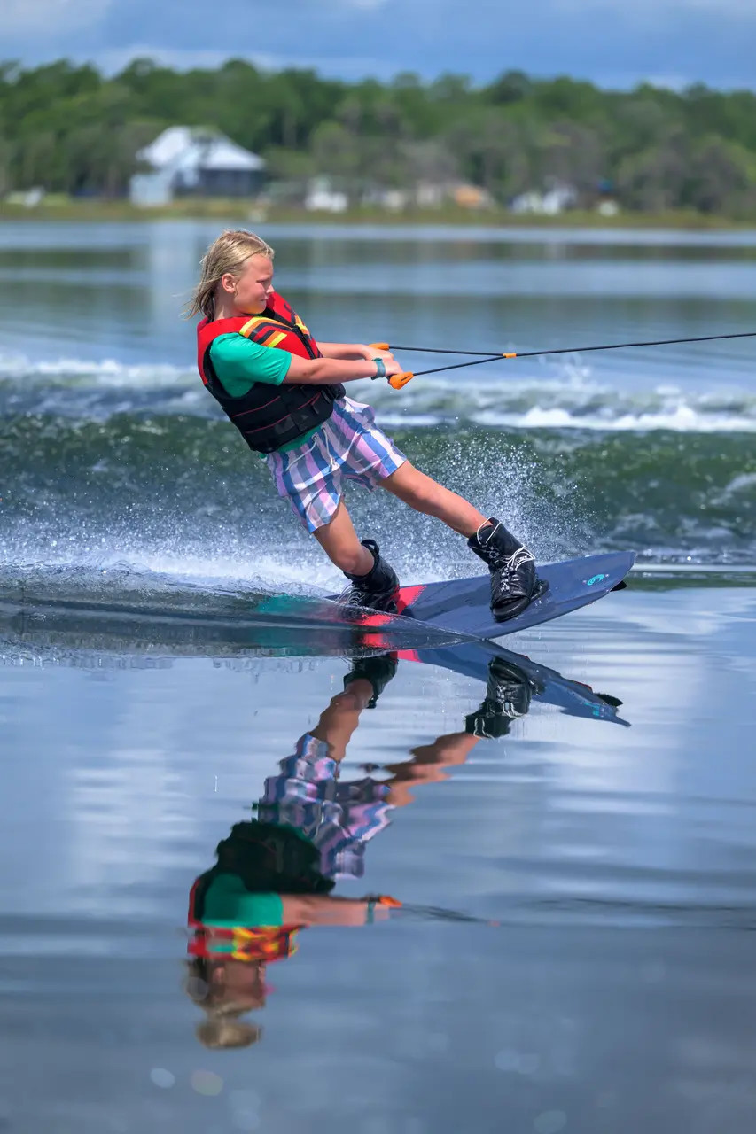 Young rider using the Connelly Surge Wakeboard on the lake