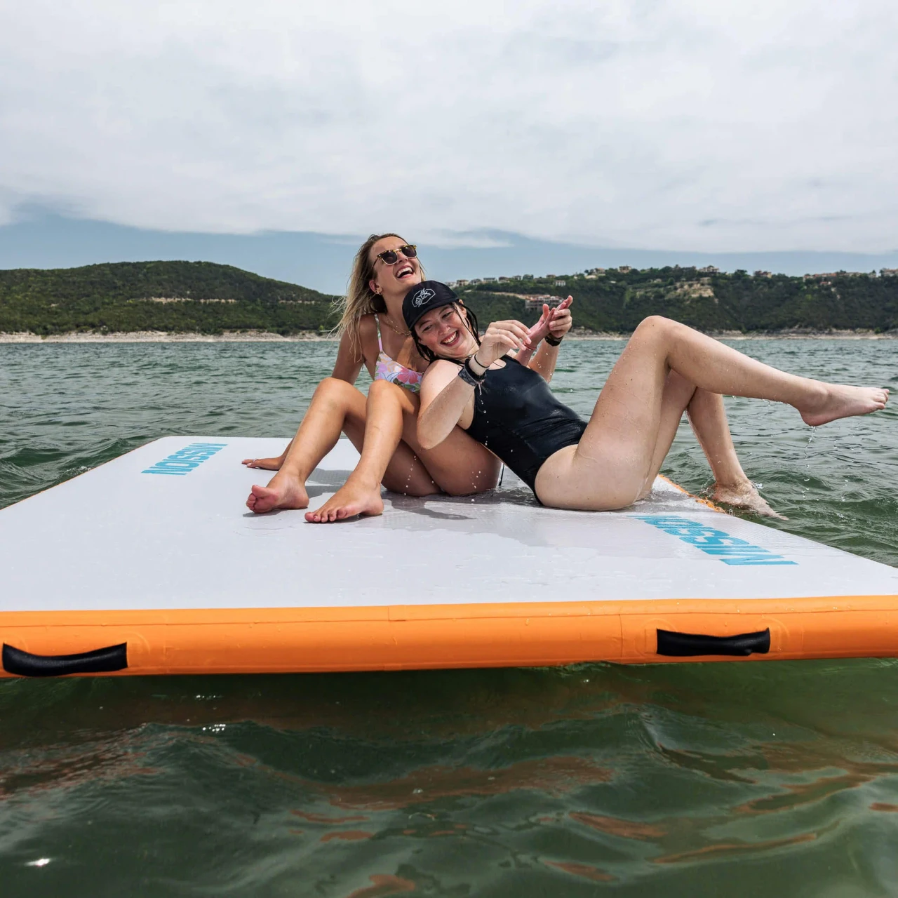 Mission REEFMAT inflatable water mat floating beside a boat on a lake