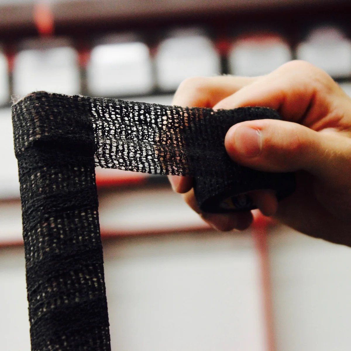 Howies Stretch Grip Hockey Tape wrapped around a hockey stick handle and knob for a cushioned grip
