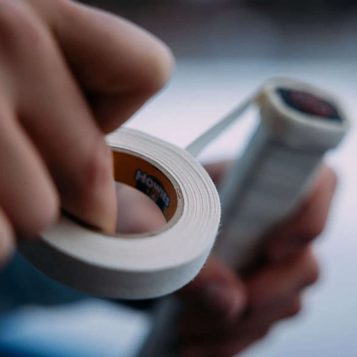 Howies white 1/2-inch cloth hockey tape wrapped around a hockey stick handle to build a custom knob
